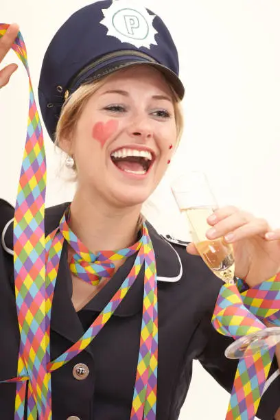 Laughing blond woman dressed as a police woman on a carnival party.