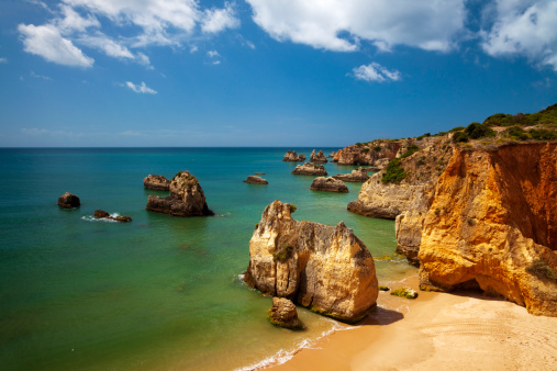 Famous beach Praia da Rocha in Portugal with huge rocks on the beach.