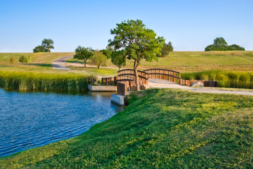 summer footbridge and lake In Lubbock Texas.