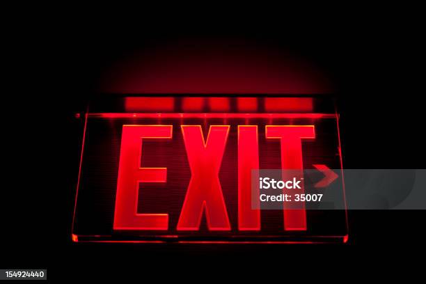 A Red Illuminated Exit Sign On Black Stock Photo - Download Image Now - Exit Sign, Leaving, Lighting Equipment