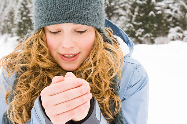 young woman warming up her hands. stock photo