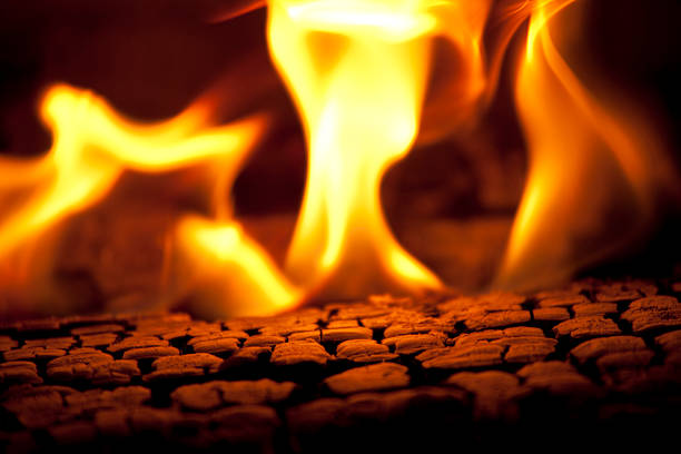Burning Fire Hot coals and flames emitting from a hot burning fire. wood burning stove stock pictures, royalty-free photos & images