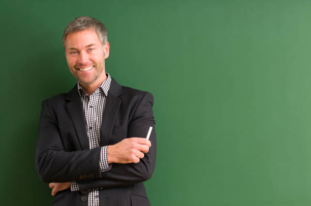 smiling teacher at blackboard