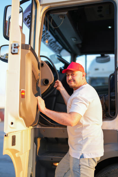 istock driver red hat man riding in white truck 1549250922