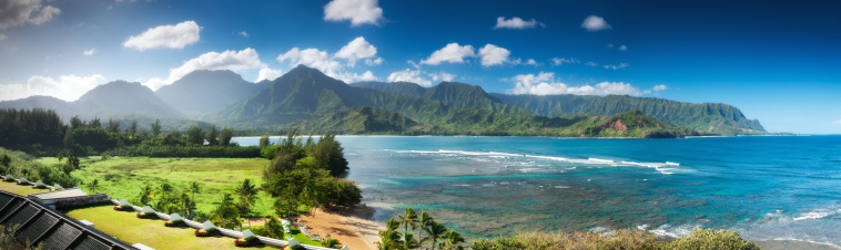 Tremendous blue sky view of Hanalei Bay and the Emerald Mountains including famed Bali Hai on the island of Kauai. High resolution multi-image panoramic. Taken from the prestigious 5 star St. Regis Resort.