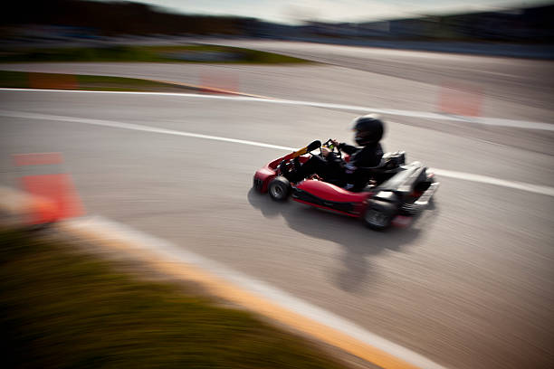competitive go kart racing offuscata - go carting foto e immagini stock