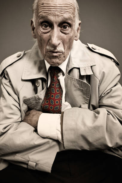 istock Gentle old man looking mischievous in a raincoat _ vertical 154925614