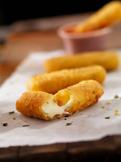 knusprige mozzarella-sticks - cheese focus on foreground on top of portion stock-fotos und bilder