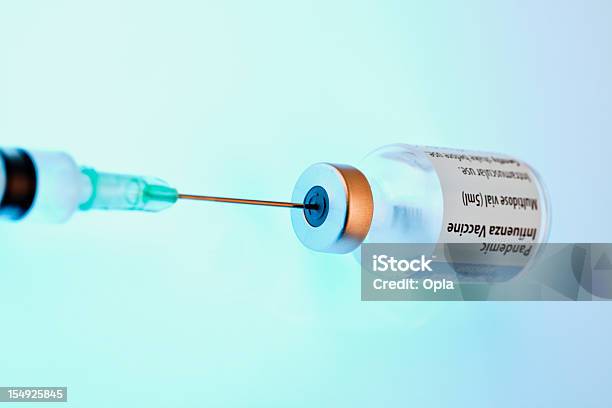 Bottle Of Vaccine With Syringe Stock Photo - Download Image Now - Vaccination, Blue, Color Image