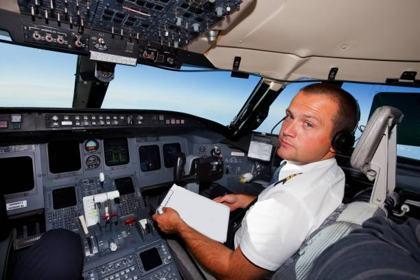 istock Young co-pilot at work in a cabin of commercial jet 154926241