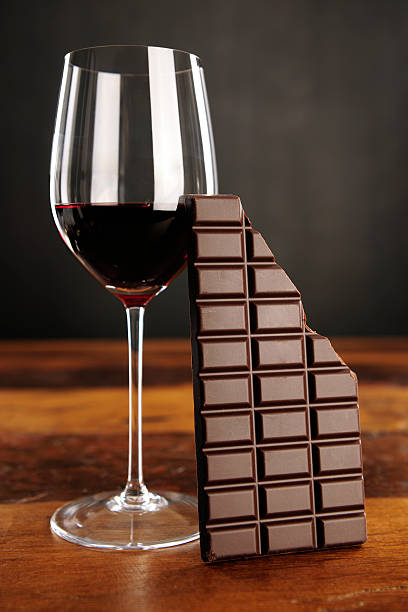 Glass of red wine and chocolate bar stock photo