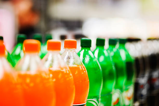 Lots of soda bottles in various flavours all lined up stock photo