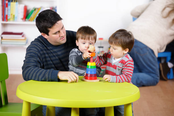 istock Father/ Carer Playing With Identical Twin Boys 154926394