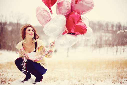 young adult female outdoors heart valentines balloons in hand
