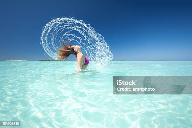 Woman Splashing Water In Lagoon Stock Photo - Download Image Now - Beach, One Woman Only, Women