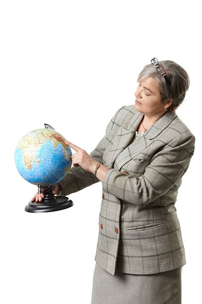 istock Mature female teacher explaining on globe 154926641