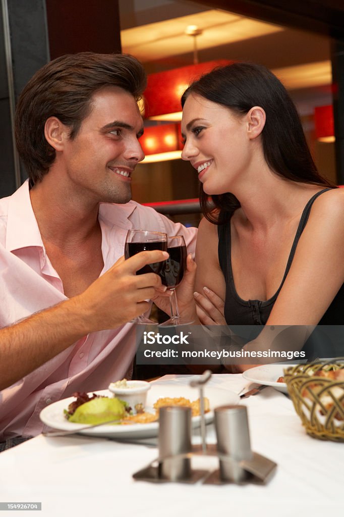 Casal jovem desfrutando de refeição em restaurante - Foto de stock de Adulto royalty-free