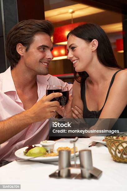 Foto de Casal Jovem Desfrutando De Refeição Em Restaurante e mais fotos de stock de Adulto - Adulto, Beber, Bebida alcoólica