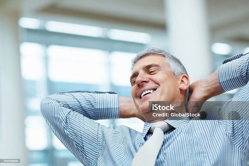 Business man relaxing in the office Business man relaxing in his office with a satisfied expression Happiness Stock Photo