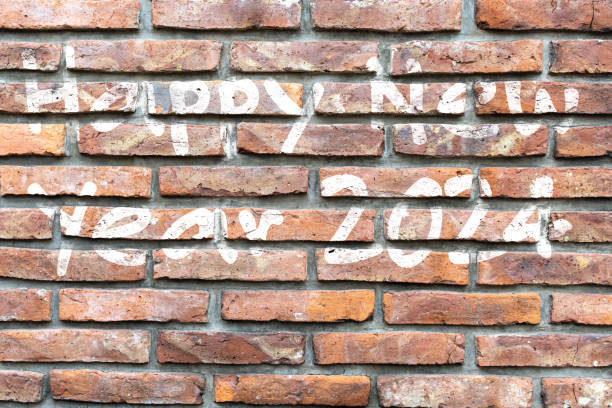 istock Brick wall with Happy New Year 2024 message in very soft white. 1549268564