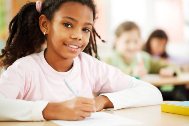 istock Girl is writing in her notebook at the classroom 154926935