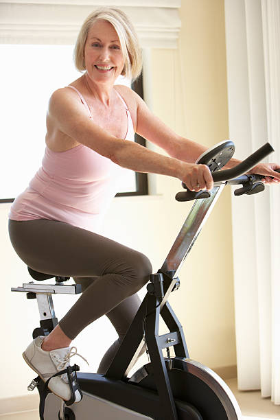 istock Senior Woman On Exercise Bike 154926966