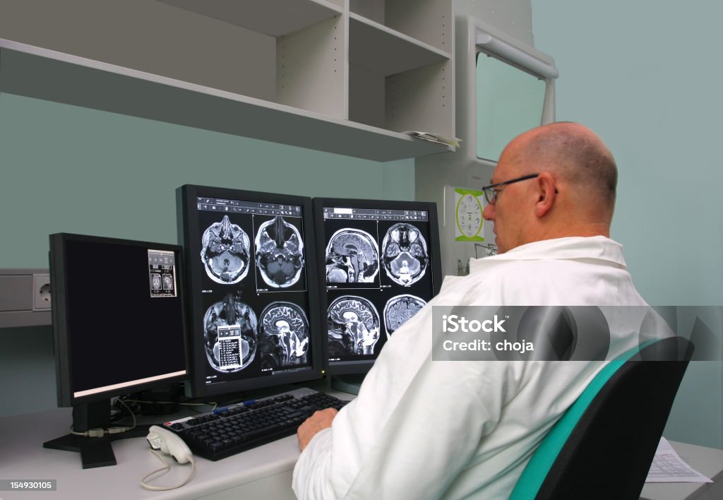 Radiologist is examing MRI scans  Analyzing Stock Photo