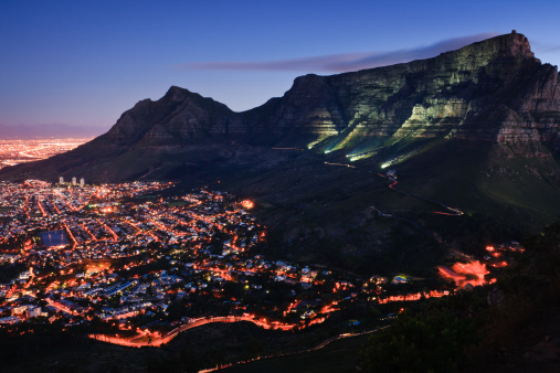 View over Table Mountain and the city bowl from Lion's Head mountain at dusk. Cape Town, South Africa.