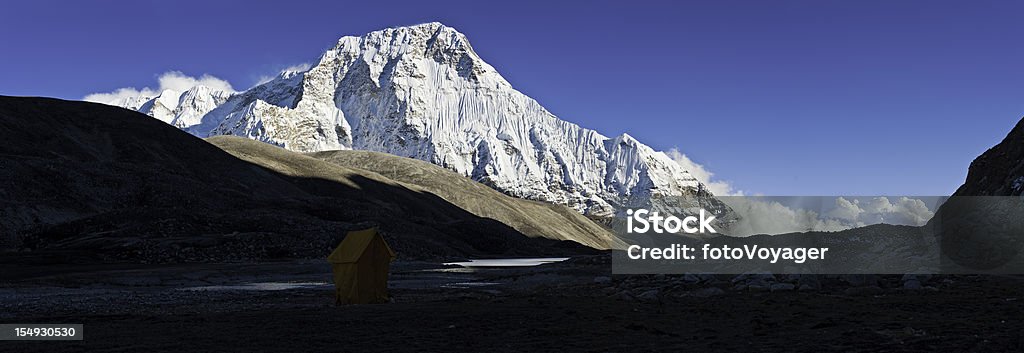 Himalayas Chamlang snow mountain summit wilderness panorama Nepal Deep blue high altitude panoramic skies over the snow capped summit and dramatic hanging glaciers of the north west face of Chamlang (7319m) overlooking the remote Hongu valley deep in the Makalu Barun National Park, Himalayas, Nepal. ProPhoto RGB profile for maximum color fidelity and gamut. Adventure Stock Photo