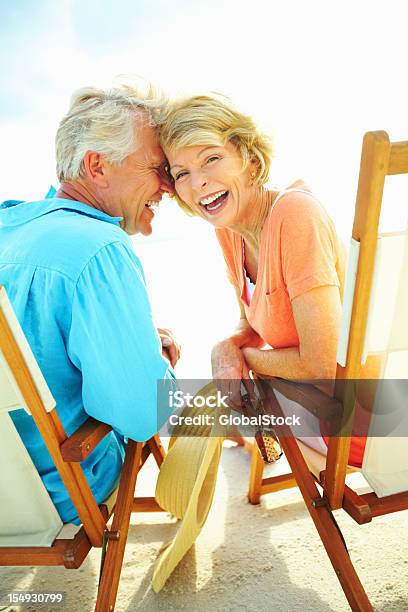 Couple Laughing While Enjoying The Beach Stock Photo - Download Image Now - Fun, Summer, Senior Adult