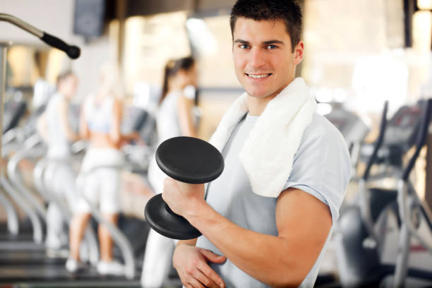 istock Man doing exercise with a dumbbells at gym. 154930842