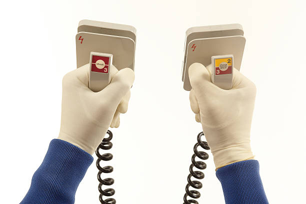 Defibrillator Two hands holding a defibrillator. defibrillator photos stock pictures, royalty-free photos & images