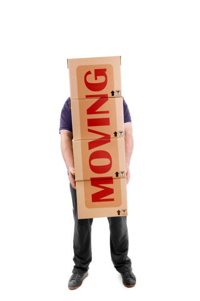 istock Man carrying boxes with a big MOVING sign across them 154930967