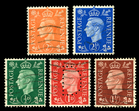 Old used stamps of Great Britain scanned on black background. In aRGB colorspace for optimal printing.