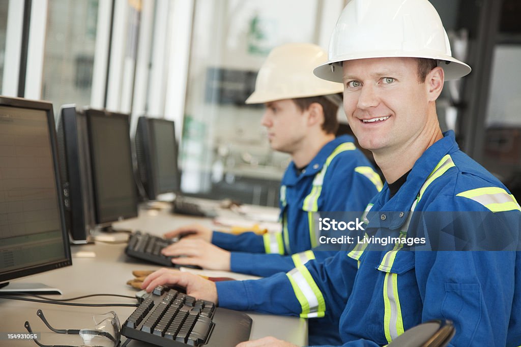 Industrial Workers Industrial workers working on computers in an office or classroom. Office Stock Photo