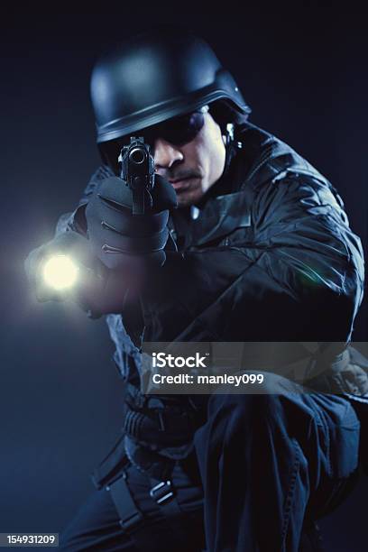 Swat Member Kneeling With Gun And Flashlight Stock Photo - Download Image Now - Adult, Adults Only, Armed Forces