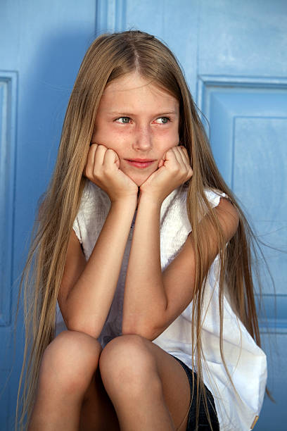 beautiful young girl in a T-shirt lifting up her hair with two hands