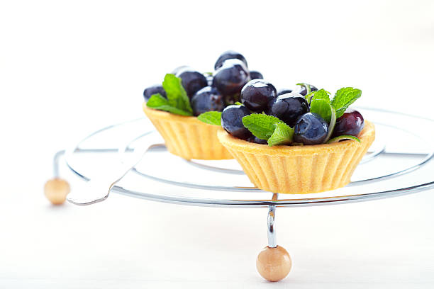 Two sweet cakes with blueberry fruits and honey