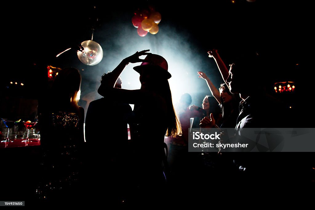 Shadow of young people who are dancing in night club. Silhouette of a people who are dancing in dark of disco club.    Adult Stock Photo