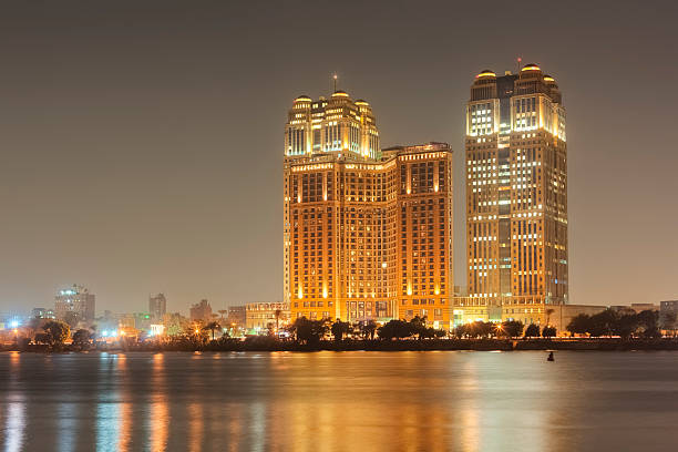 Cairo Skyline - Fairmont Nile City Towers high-rise buildings line the eastern edge of the Nile in central Cairo - View from the Zamalek district on Gezira Island riverside cairo stock pictures, royalty-free photos & images