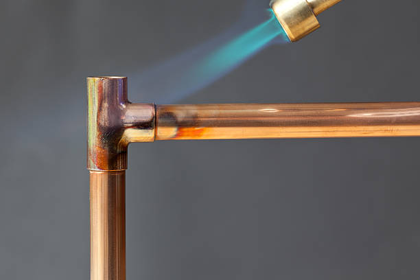 istock Gas flame heating copper piping before soldering 154931726