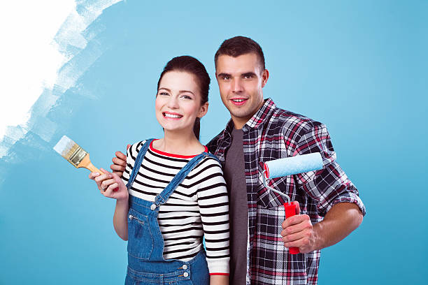istock Young couple painting wall 154931739