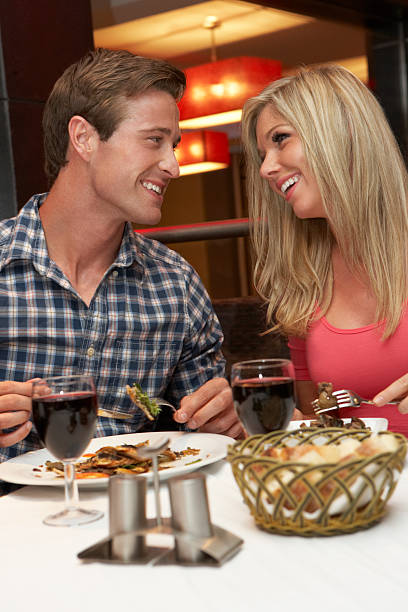 istock Young Couple Enjoying Meal In Restaurant 154931897