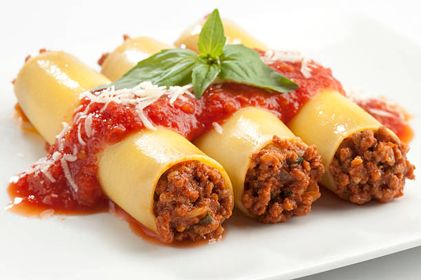 Cannelloni stuffed with minced meat on a white plate