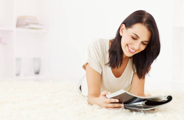 istock Woman Reading a Magazine on the Floor 154932441