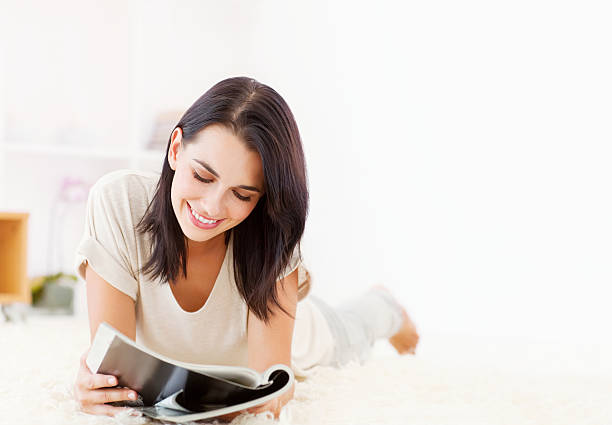 istock Woman Reading a Magazine on the Floor 154932452