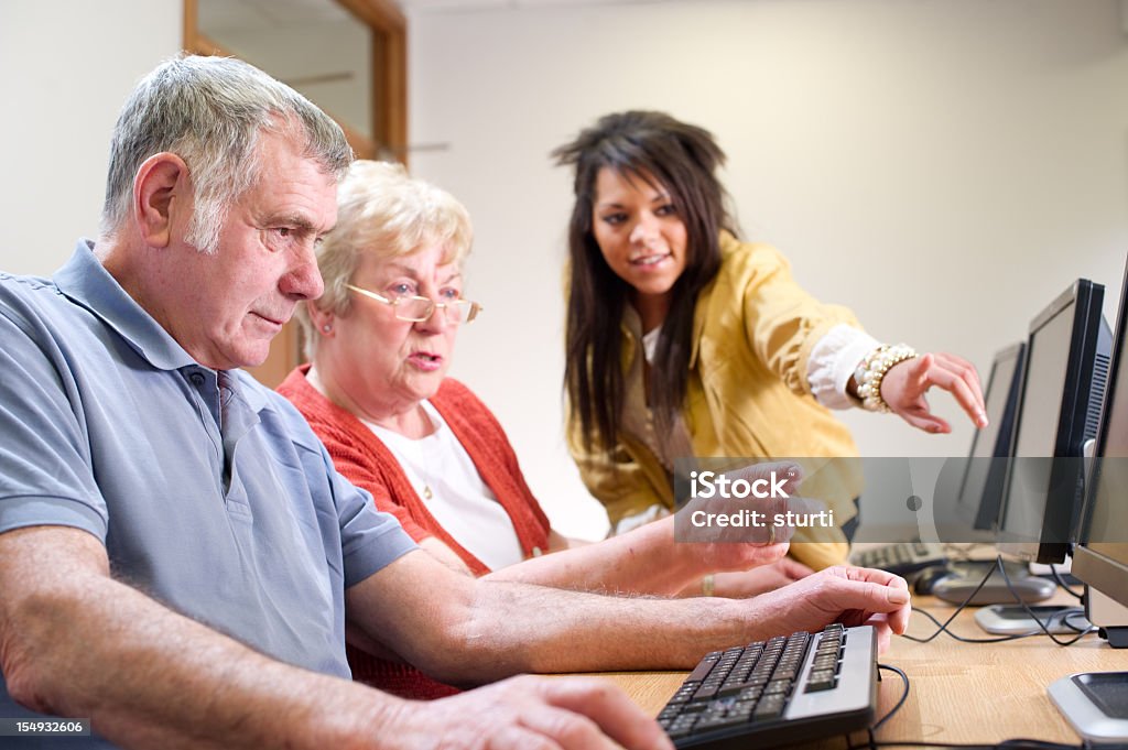 computer class Senior couple get IT help 20-24 Years Stock Photo