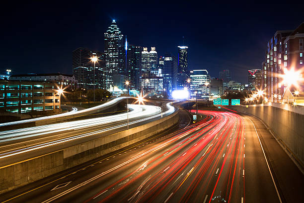 Atlanta city office buildings and highway traffic motion blur across the freeway