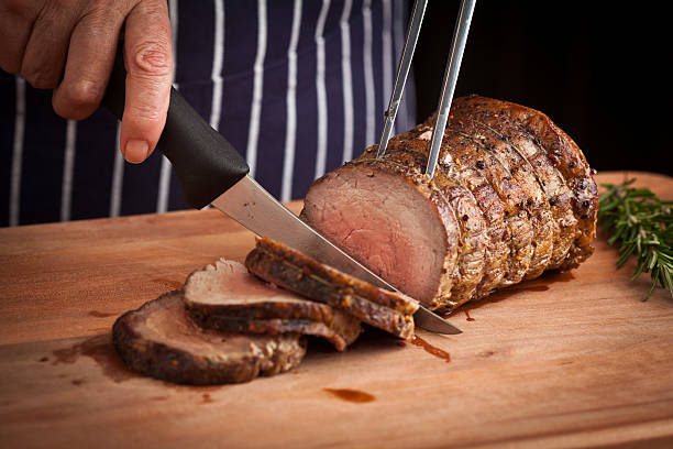 Chef carving Roast Beef.