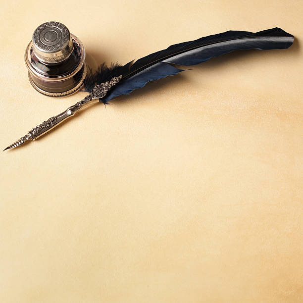 Quill pen and inkwell stock photo